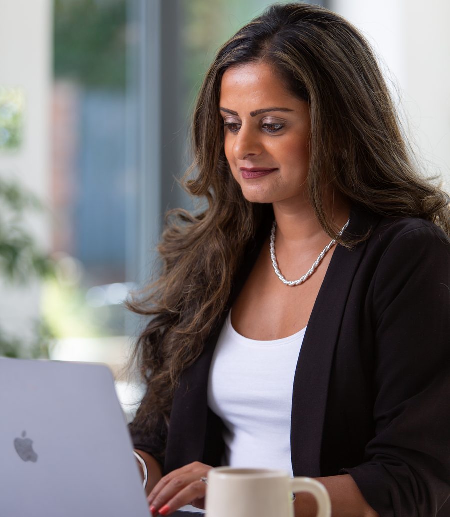 Dr Neesha Patel working at her laptop